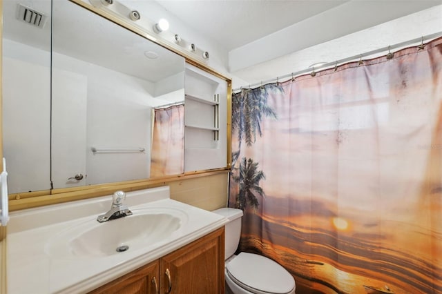 full bath with toilet, vanity, and visible vents