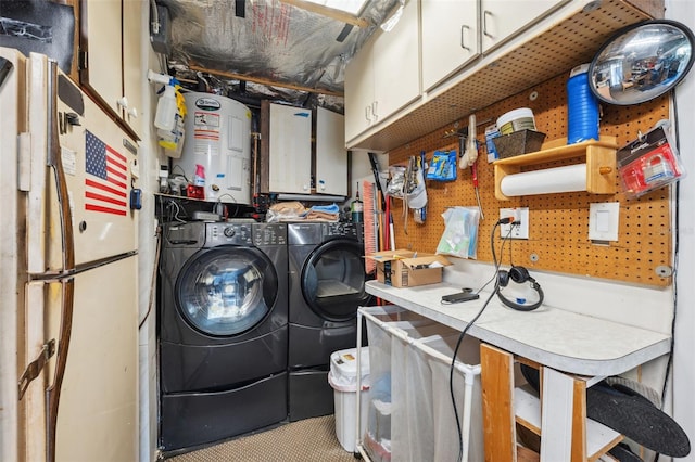 clothes washing area with electric water heater and separate washer and dryer