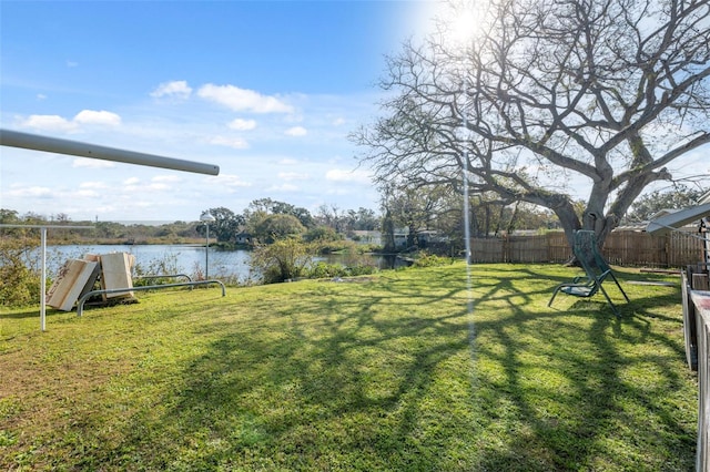 view of yard featuring a water view and fence