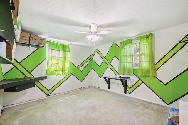 game room featuring ceiling fan, carpet floors, and a textured ceiling
