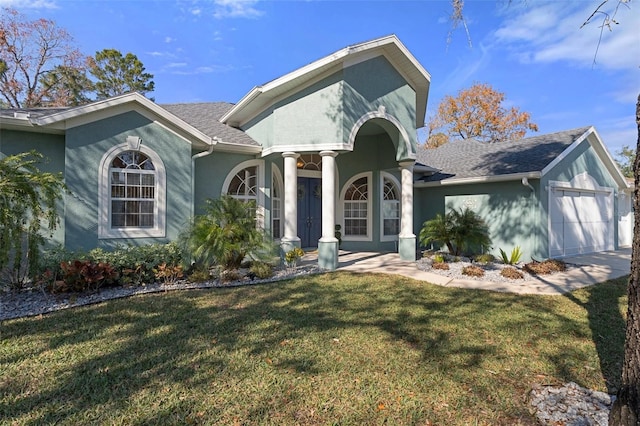 view of front facade with a front yard and a garage