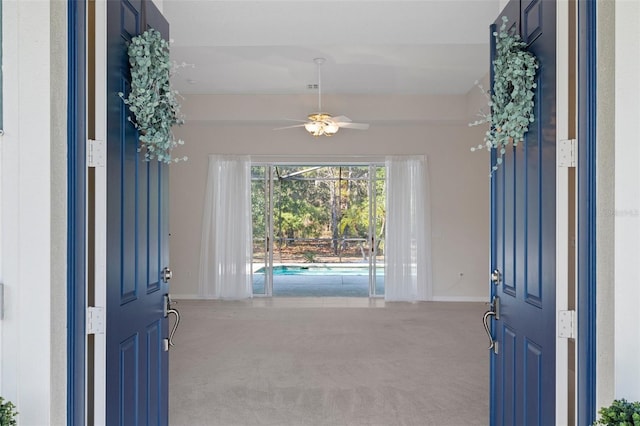 carpeted foyer featuring ceiling fan