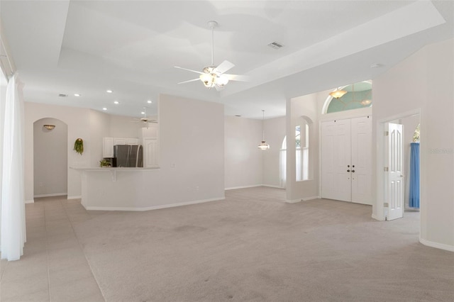 interior space featuring ceiling fan and light carpet