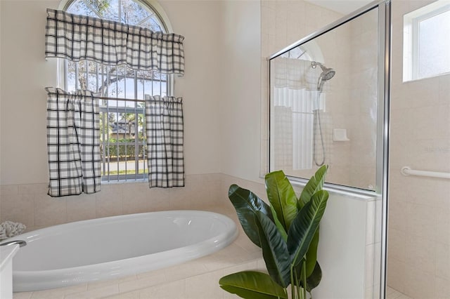 bathroom featuring separate shower and tub