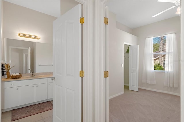 bathroom featuring tile patterned flooring, ceiling fan, and vanity