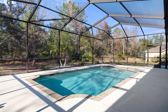 view of pool featuring a patio and glass enclosure