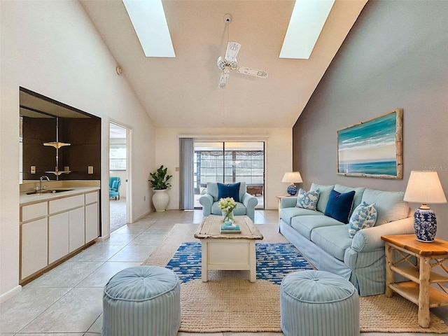 tiled living room featuring high vaulted ceiling, ceiling fan, a skylight, and sink