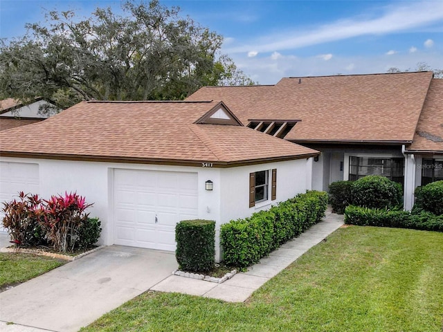 ranch-style home with a front yard and a garage