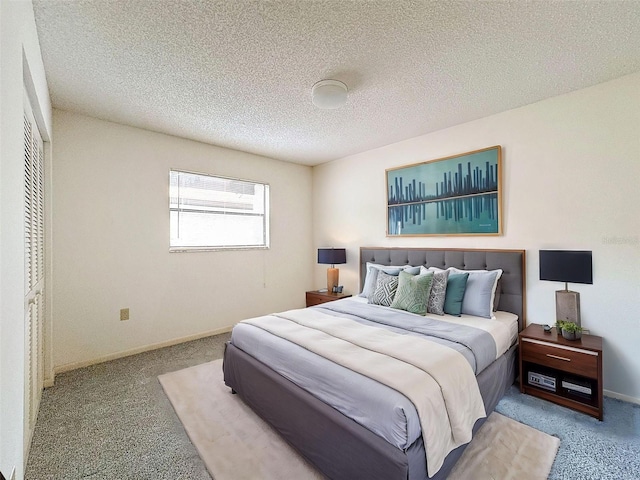 carpeted bedroom featuring a textured ceiling