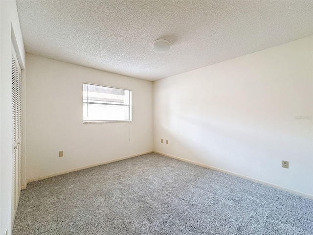 unfurnished bedroom with a textured ceiling, a closet, and carpet flooring