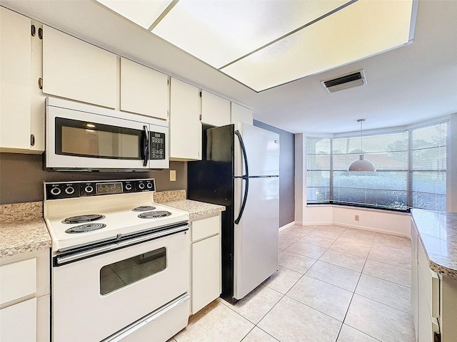 kitchen with light tile patterned flooring, white cabinetry, hanging light fixtures, and appliances with stainless steel finishes