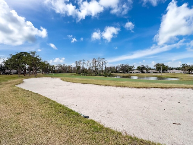 view of property's community with a yard and a water view