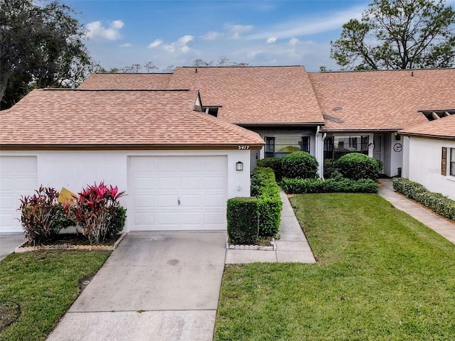 single story home with a garage and a front lawn