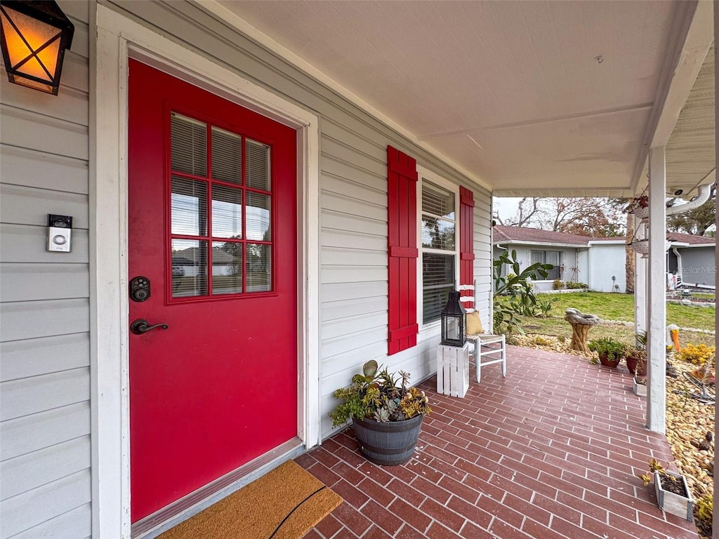 doorway to property featuring covered porch