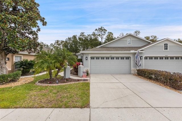 ranch-style house featuring a garage and a front lawn