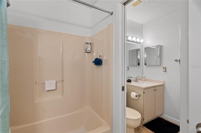 full bathroom featuring vanity, toilet, a textured ceiling, and shower / washtub combination