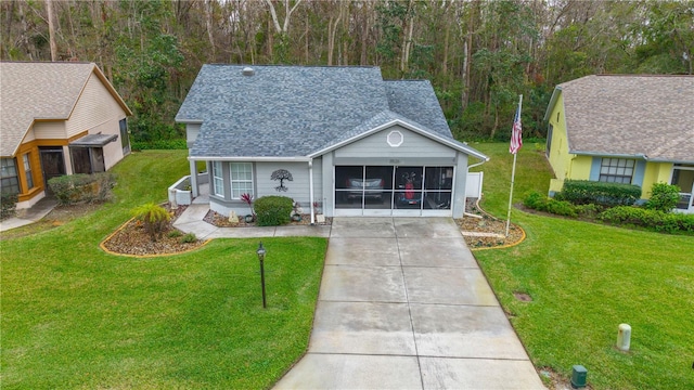 view of front of home featuring a front lawn and a sunroom