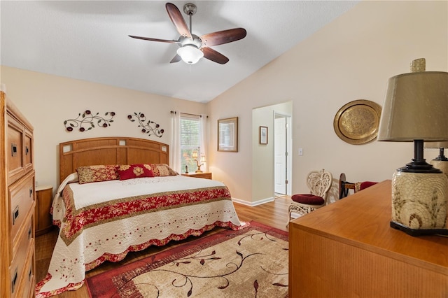 bedroom with light hardwood / wood-style floors, vaulted ceiling, and ceiling fan