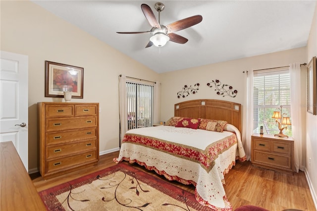 bedroom with ceiling fan, light hardwood / wood-style floors, and lofted ceiling