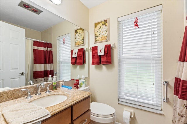 bathroom featuring vanity and toilet