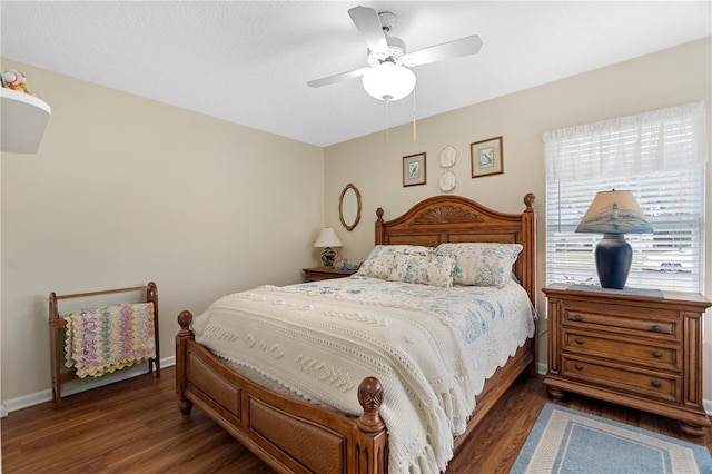 bedroom featuring ceiling fan and dark wood-type flooring