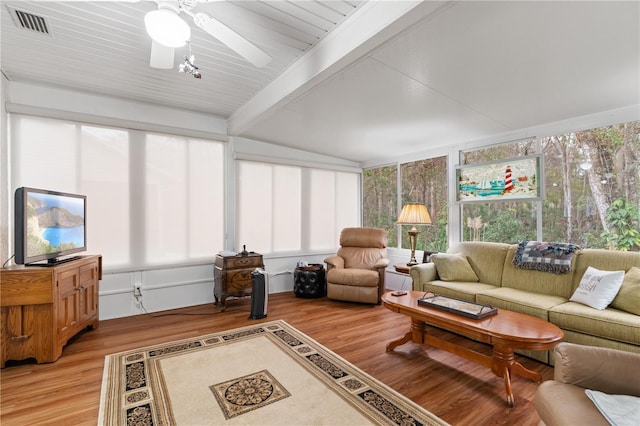 sunroom / solarium with beam ceiling and ceiling fan