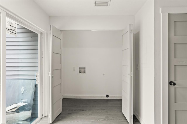 clothes washing area featuring dark hardwood / wood-style flooring and hookup for a washing machine