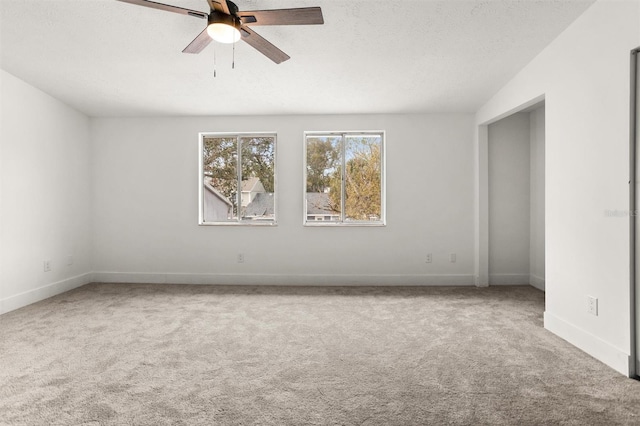 unfurnished room with ceiling fan and carpet floors