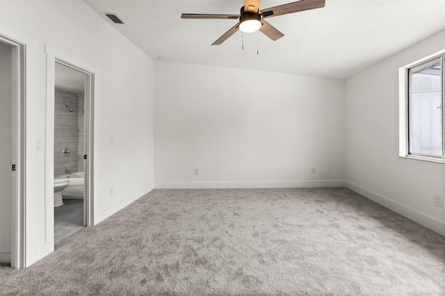 unfurnished bedroom with carpet, ceiling fan, and ensuite bath