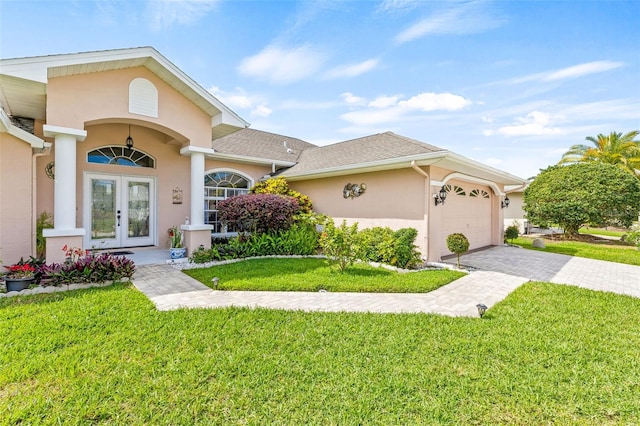 view of front of house with a garage, french doors, and a front yard