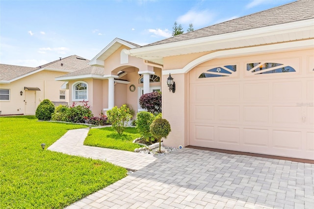 view of front facade with a front yard and a garage