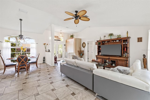 living room featuring lofted ceiling, french doors, and ceiling fan