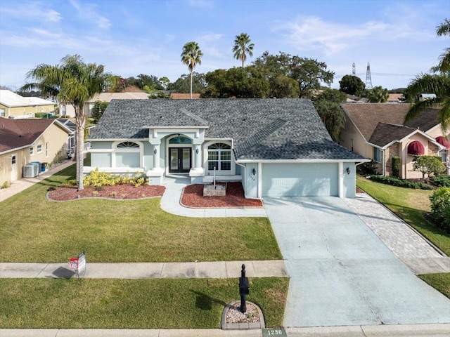 ranch-style house featuring a garage, central air condition unit, and a front lawn