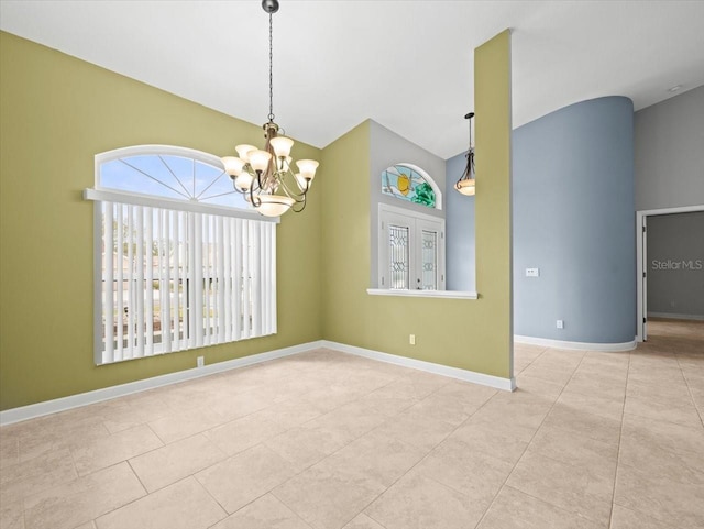 spare room with high vaulted ceiling, light tile patterned floors, and a notable chandelier