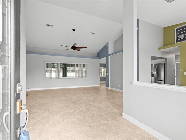 unfurnished living room featuring ceiling fan, high vaulted ceiling, and light tile patterned floors