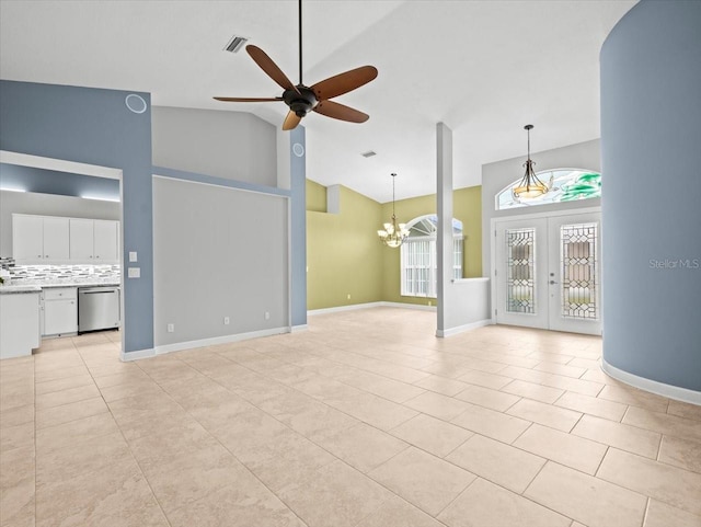 unfurnished living room with french doors, high vaulted ceiling, ceiling fan with notable chandelier, and light tile patterned floors