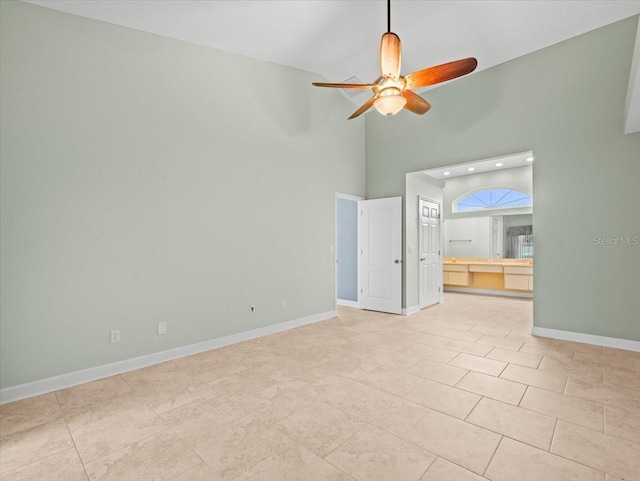 interior space featuring a high ceiling and ceiling fan