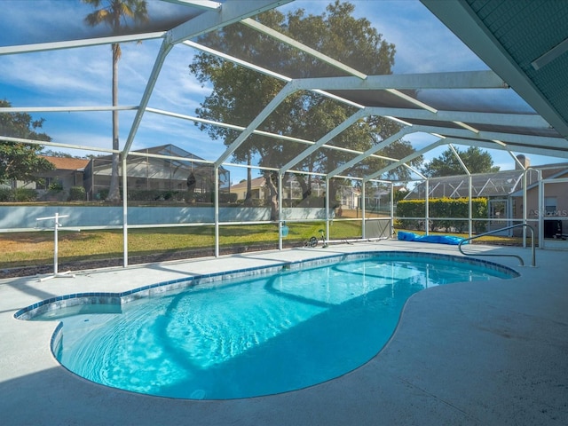 view of pool featuring a water view, a patio area, glass enclosure, and a lawn