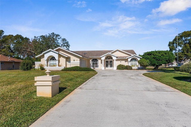 ranch-style home featuring a front yard