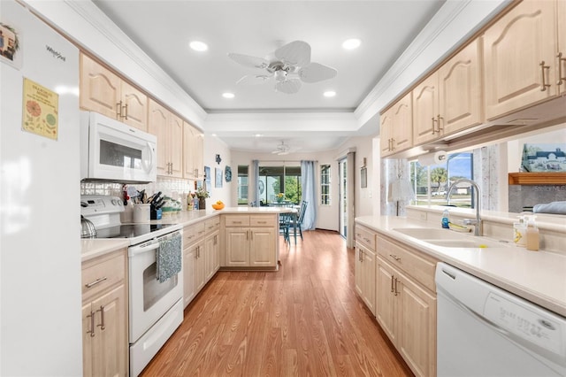 kitchen with sink, light brown cabinets, white appliances, ceiling fan, and kitchen peninsula