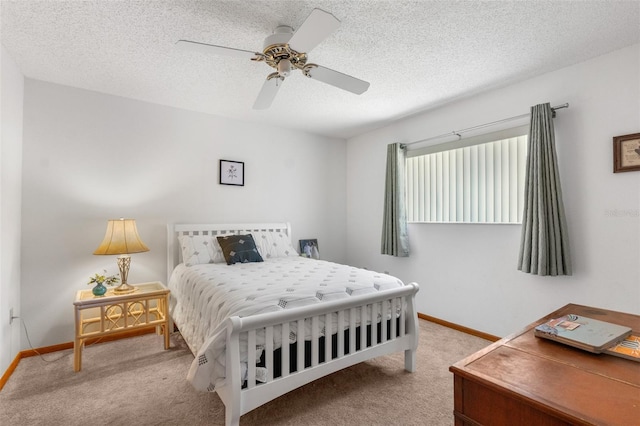 bedroom featuring ceiling fan, light carpet, and a textured ceiling