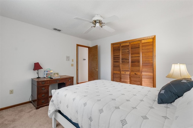 bedroom featuring ceiling fan, a closet, and light carpet