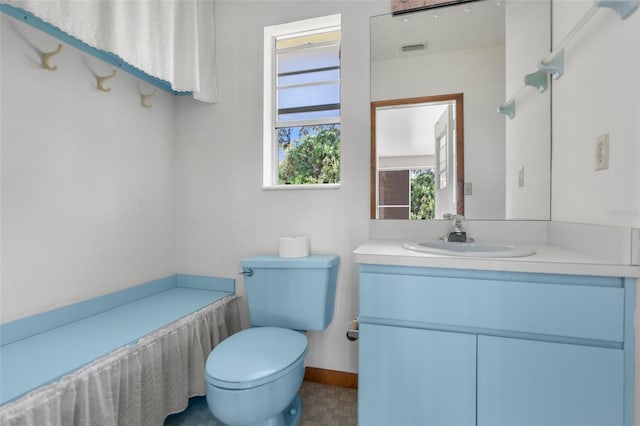 bathroom featuring toilet and vanity