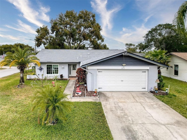 ranch-style house featuring a front yard and a garage