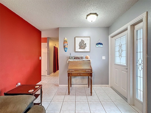 tiled foyer entrance featuring a textured ceiling