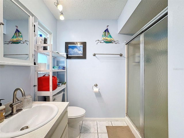 bathroom with a textured ceiling, vanity, an enclosed shower, and toilet