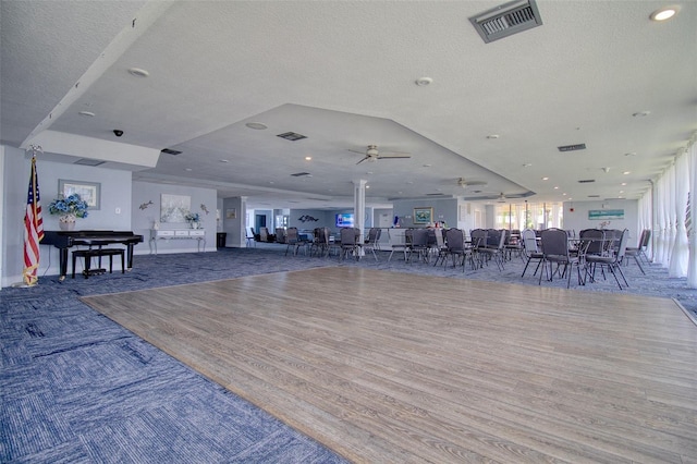 interior space featuring wood-type flooring, a textured ceiling, and ceiling fan