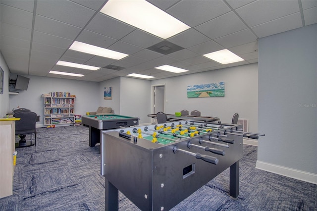 playroom featuring a paneled ceiling and dark carpet