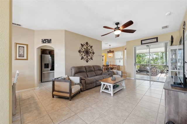 tiled living room featuring ceiling fan