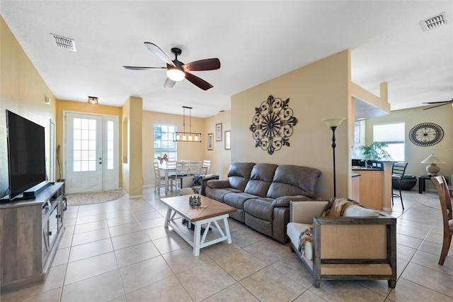 tiled living room with ceiling fan